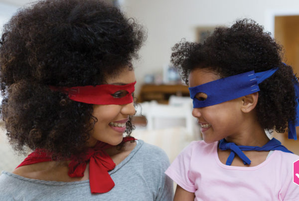 mother and daughter with superhero masks